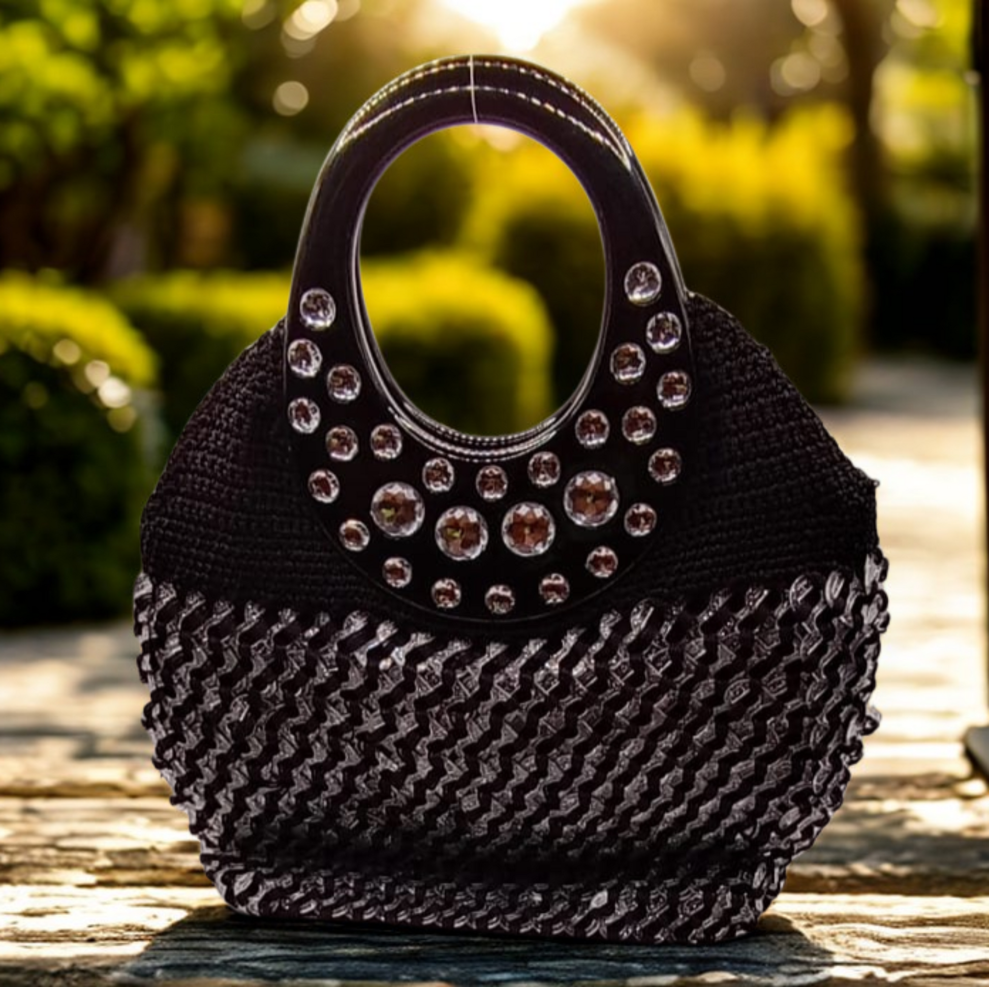 Bolso artesanal crochet negro con gemas plateadas brillantes.